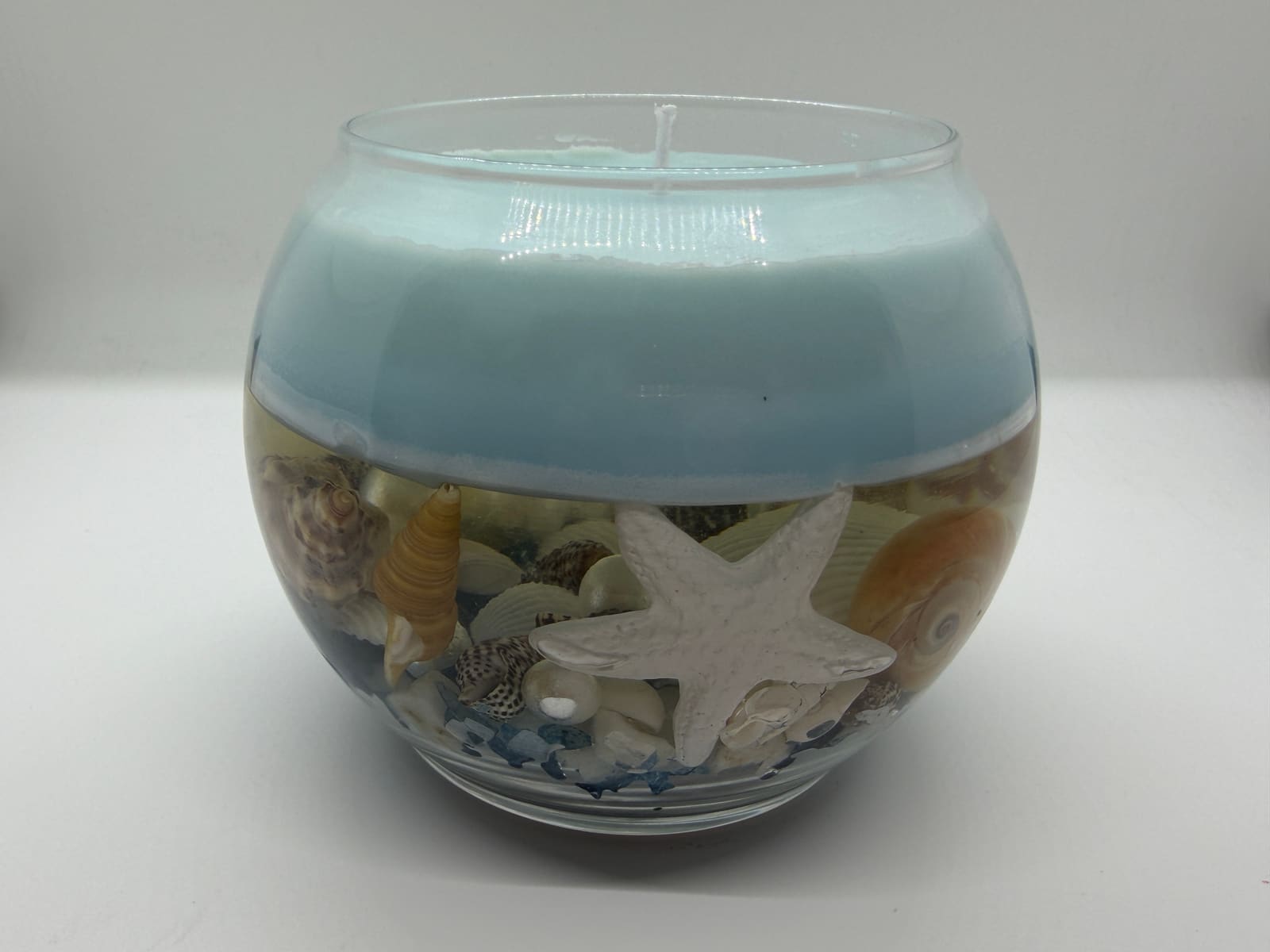 Coastal Shell jar candle with seashells and a starfish set in the glass